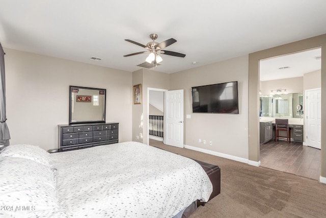 bedroom featuring dark colored carpet, ensuite bathroom, and ceiling fan