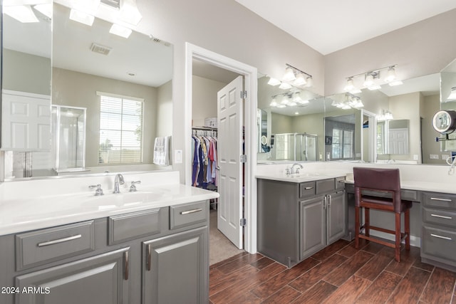 bathroom featuring vanity and a shower with shower door