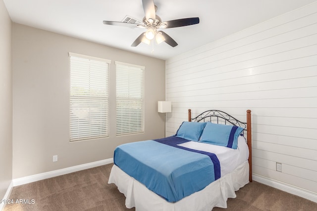 bedroom featuring ceiling fan and dark colored carpet