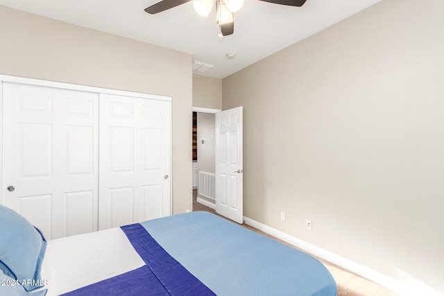 unfurnished bedroom with ceiling fan, carpet, and a closet