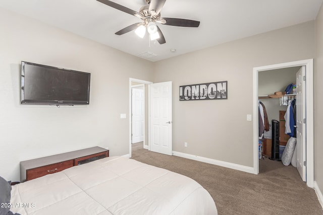 bedroom with ceiling fan, a closet, carpet, and a walk in closet