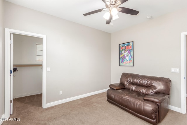 living area with light colored carpet and ceiling fan