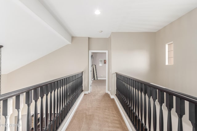 hallway featuring light colored carpet