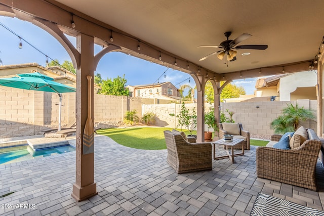 view of patio / terrace featuring ceiling fan, an outdoor hangout area, and a fenced in pool