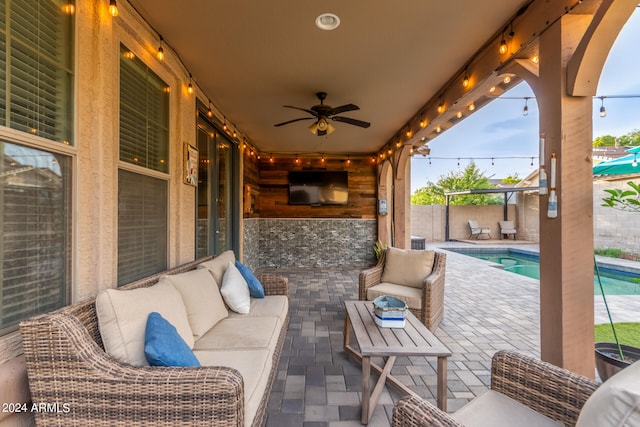 view of patio / terrace featuring a fenced in pool, an outdoor hangout area, and ceiling fan