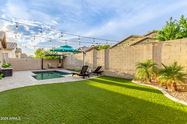 view of yard featuring a fenced in pool and a patio area