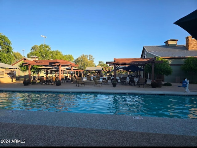 view of pool with a pergola and a patio area