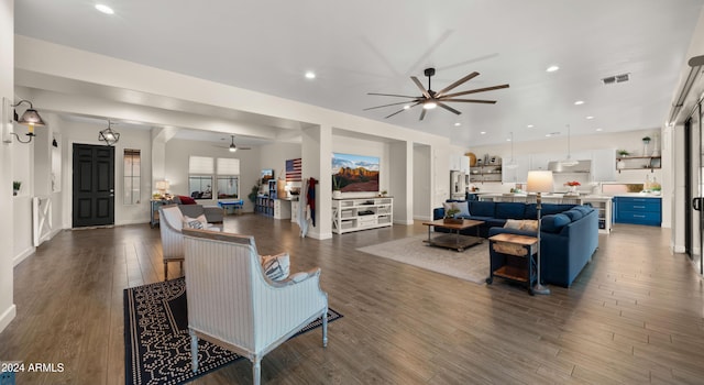 living room featuring ceiling fan and dark hardwood / wood-style floors