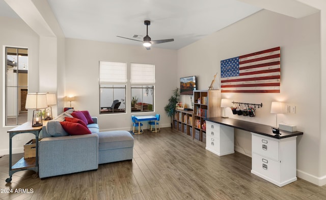 living room featuring ceiling fan and dark hardwood / wood-style floors