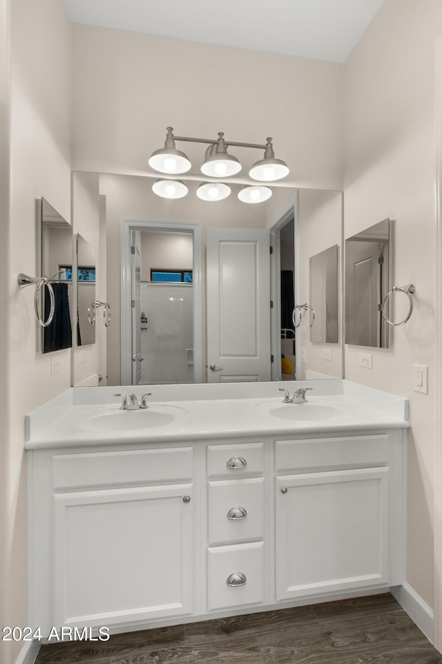 bathroom featuring a shower, hardwood / wood-style flooring, and vanity