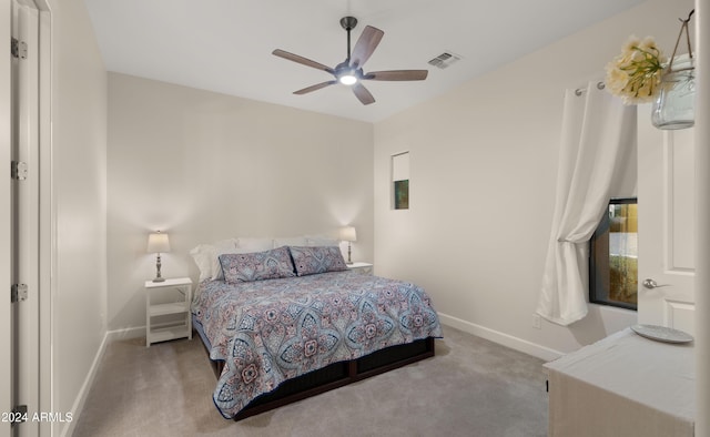 bedroom featuring light carpet and ceiling fan