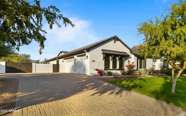 view of front of property with a front lawn and a garage