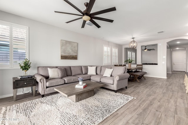 3474 W Dreamy Draw Dr, Queen Creek, AZ 85144 - living room with a ceiling fan, baseboards, light wood finished floors, arched walkways, and recessed lighting