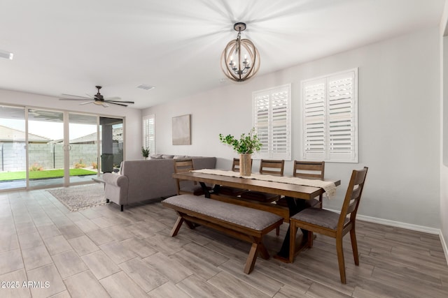 3474 W Dreamy Draw Dr, Queen Creek, AZ 85144 - dining room with light wood-type flooring, a chandelier, a ceiling fan, and baseboards