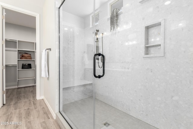 3474 W Dreamy Draw Dr, Queen Creek, AZ 85144 - bathroom with a marble finish shower, a walk in closet, and wood finished floors