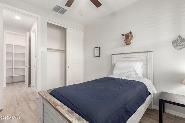 3474 W Dreamy Draw Dr, Queen Creek, AZ 85144 - bedroom featuring light wood-type flooring, a closet, baseboards, and a ceiling fan