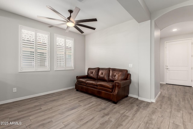 3474 W Dreamy Draw Dr, Queen Creek, AZ 85144 - sitting room featuring a ceiling fan, arched walkways, light wood-style floors, and baseboards