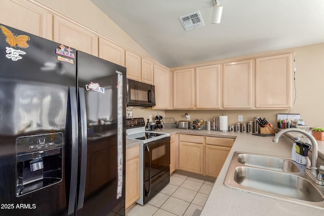 kitchen featuring a sink, visible vents, light countertops, light brown cabinetry, and black appliances