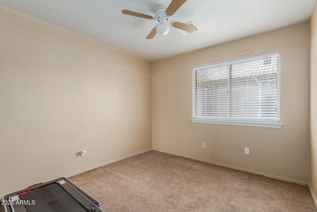 unfurnished room featuring baseboards, a ceiling fan, and light colored carpet