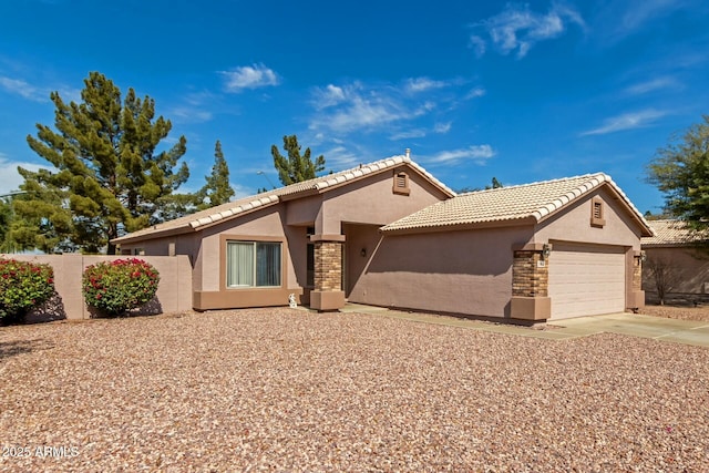 view of front of home featuring a garage, concrete driveway, fence, and stucco siding