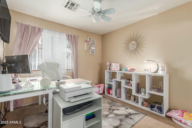home office featuring carpet, visible vents, and ceiling fan