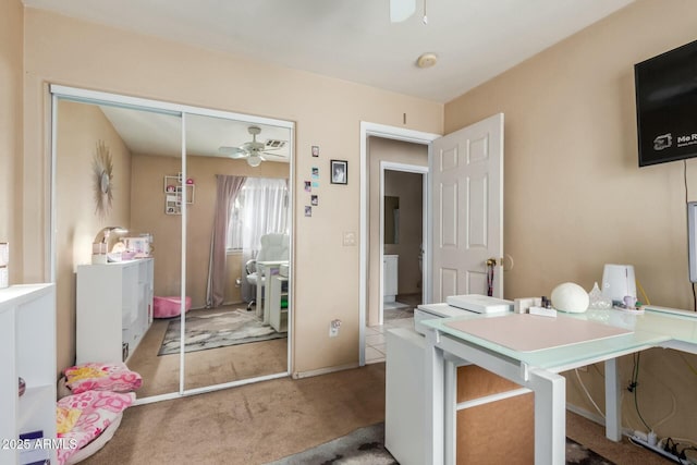 office featuring ceiling fan and light colored carpet