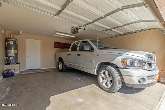 garage with baseboards, gas water heater, and a garage door opener