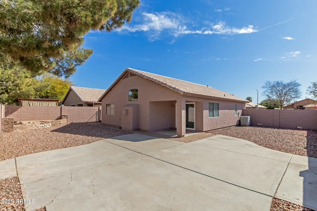 back of property featuring a patio area, cooling unit, a fenced backyard, and stucco siding