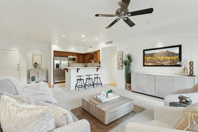 living room with recessed lighting, a ceiling fan, visible vents, and light carpet