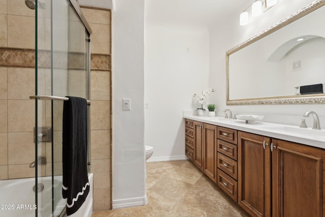 full bathroom with a sink, double vanity, toilet, combined bath / shower with glass door, and visible vents