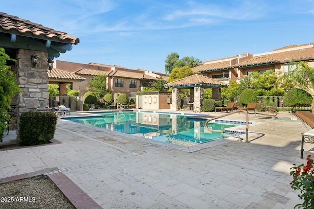 pool featuring a gazebo, a patio area, and fence