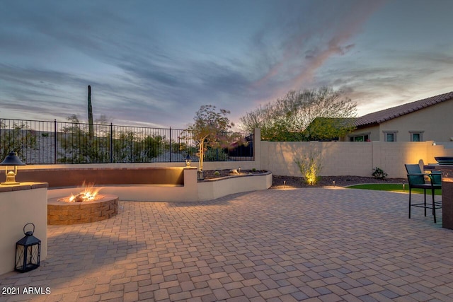 view of patio with a fenced backyard and a fire pit