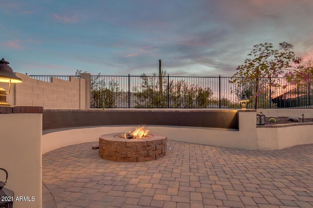 view of patio featuring a fire pit and fence