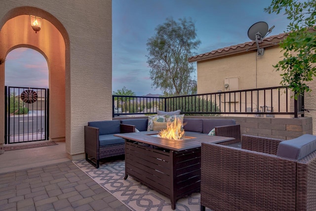 view of patio / terrace with an outdoor living space with a fire pit