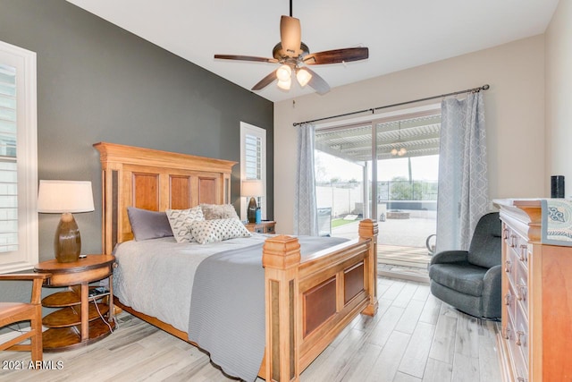 bedroom featuring access to exterior, light wood-type flooring, and a ceiling fan