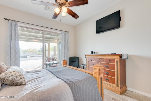 bedroom featuring ceiling fan, visible vents, baseboards, light wood-style floors, and access to exterior