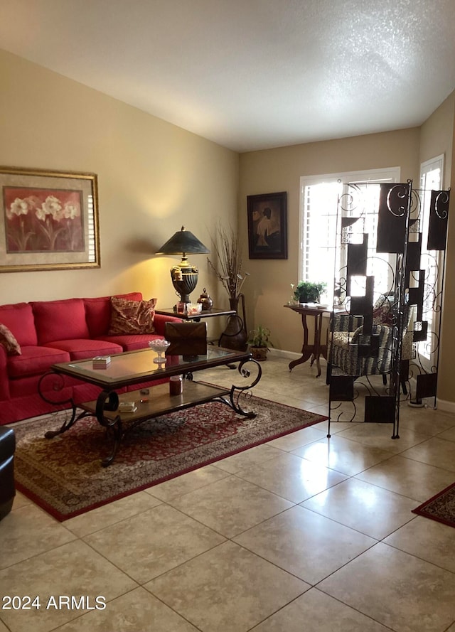 tiled living room featuring a textured ceiling