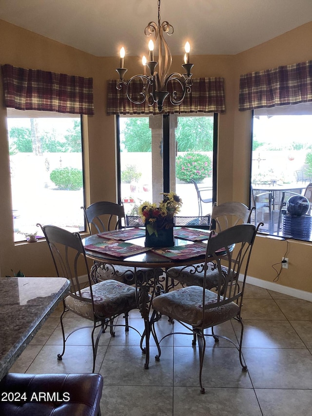 dining room with a chandelier and tile patterned floors