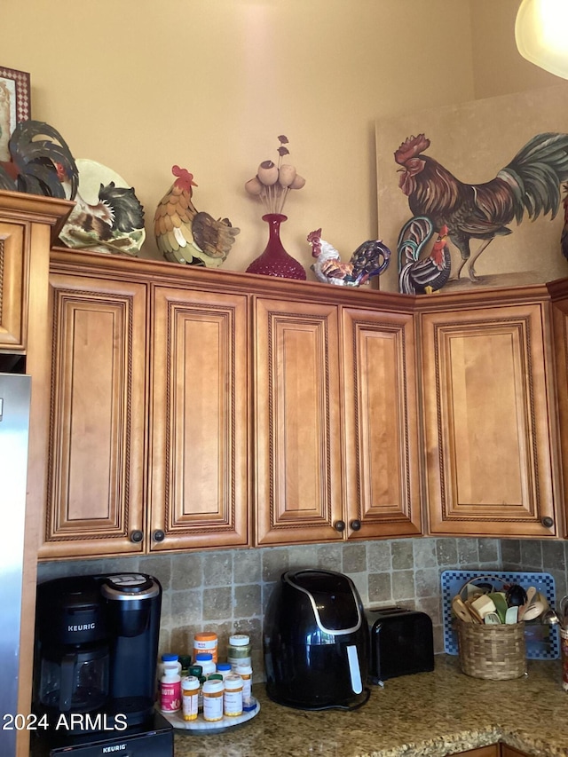 kitchen featuring stainless steel fridge and backsplash