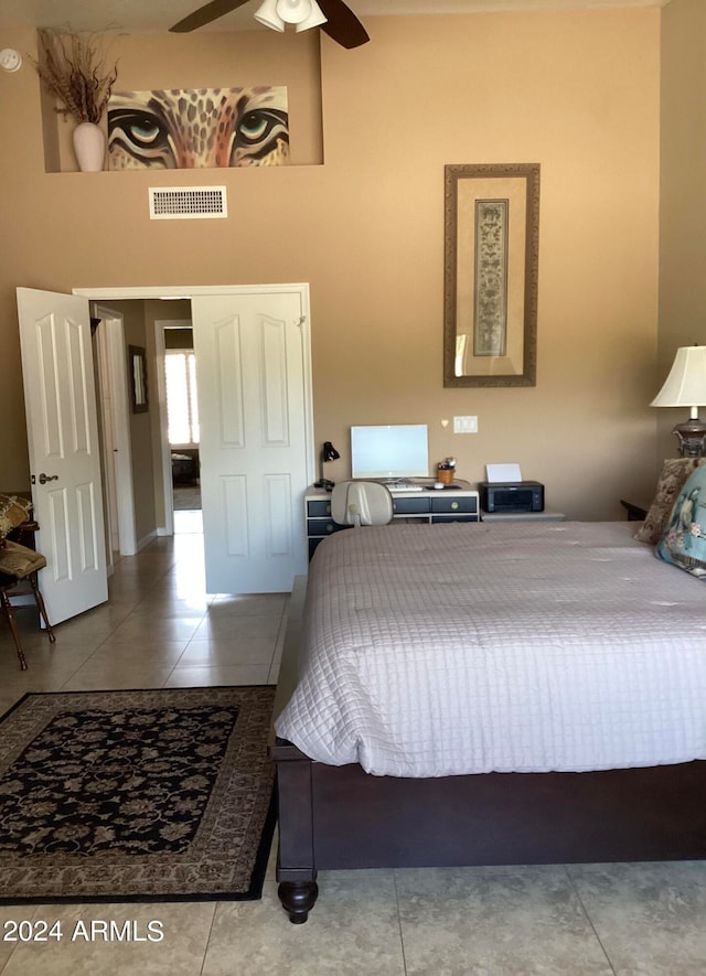 tiled bedroom with ceiling fan