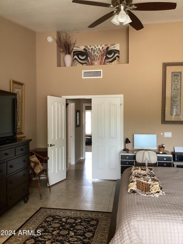 tiled bedroom with ceiling fan