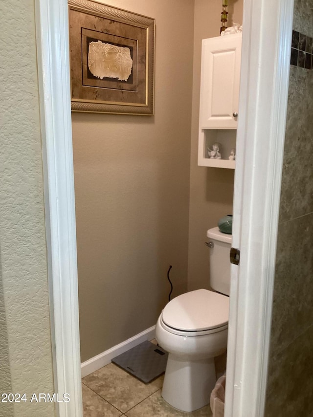 bathroom with tile patterned flooring and toilet