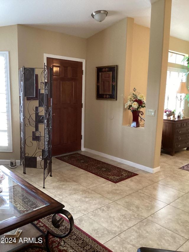 foyer entrance with light tile patterned floors