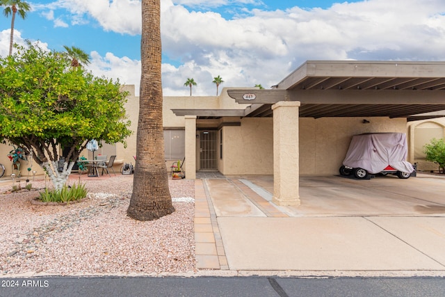 pueblo revival-style home featuring a carport