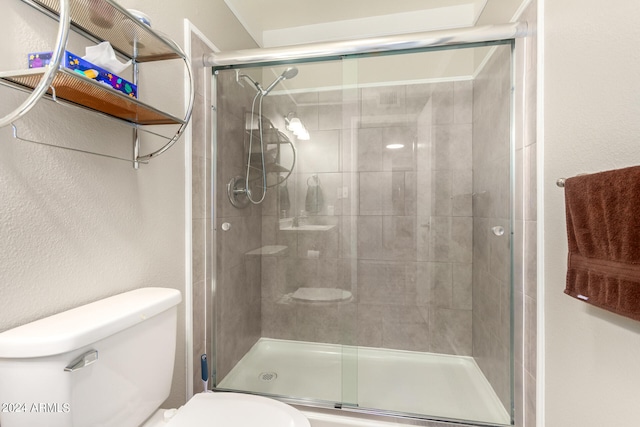 bathroom featuring toilet and an enclosed shower