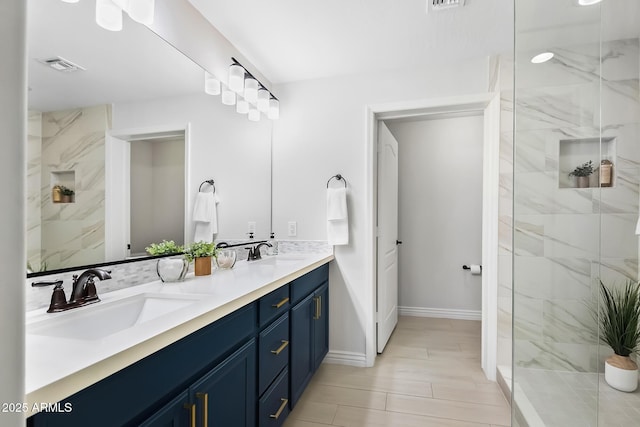 bathroom with vanity and tiled shower