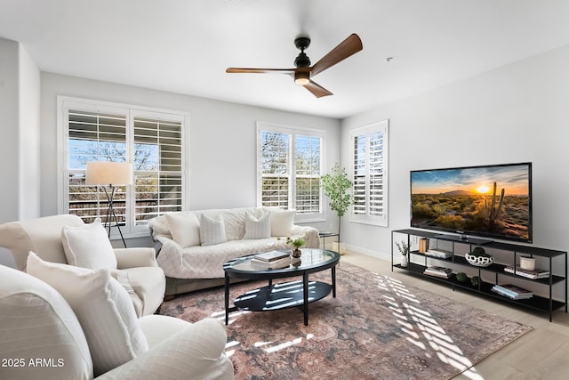 living room featuring wood-type flooring and ceiling fan