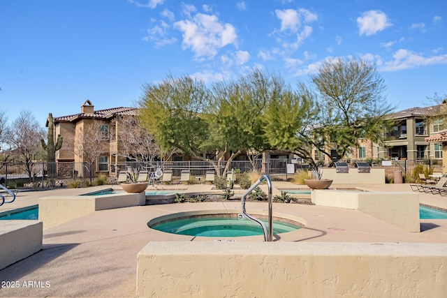 view of pool featuring a community hot tub and a patio area