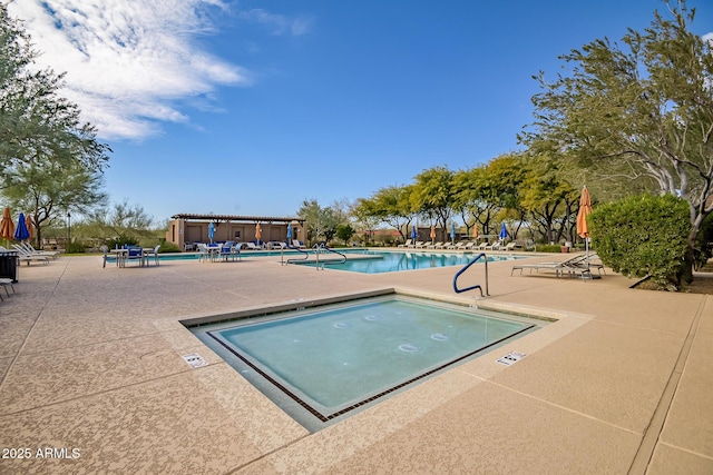 view of pool featuring a community hot tub and a patio area