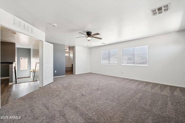 unfurnished bedroom with ceiling fan, baseboards, carpet, and visible vents